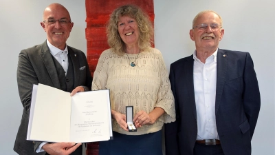 Landrat Dr. Klaus Metzger (links) und sein Vize Manfred Losinger gratulierten Marion Brülls zur Auszeichnung mit dem Ehrenzeichen des Bayerischen Ministerpräsidenten.  (Foto: Rebecca Aberer, Landratsamt)